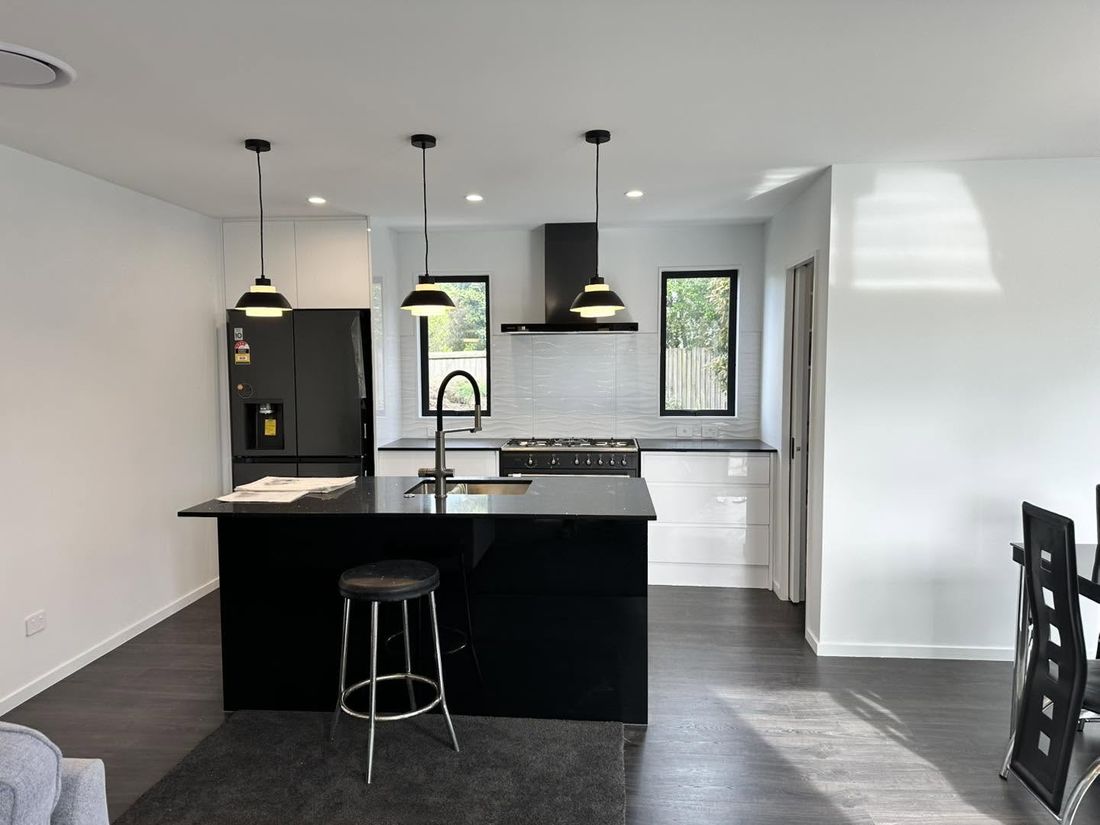 Modern kitchen with black pendant lights and recessed downlights installed by JIMED Electrical