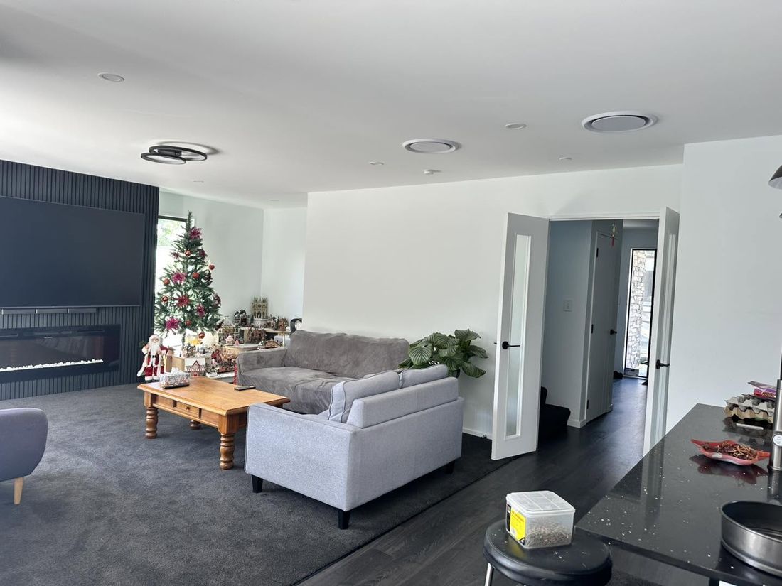 Open-plan living area with recessed downlights and ceiling speakers