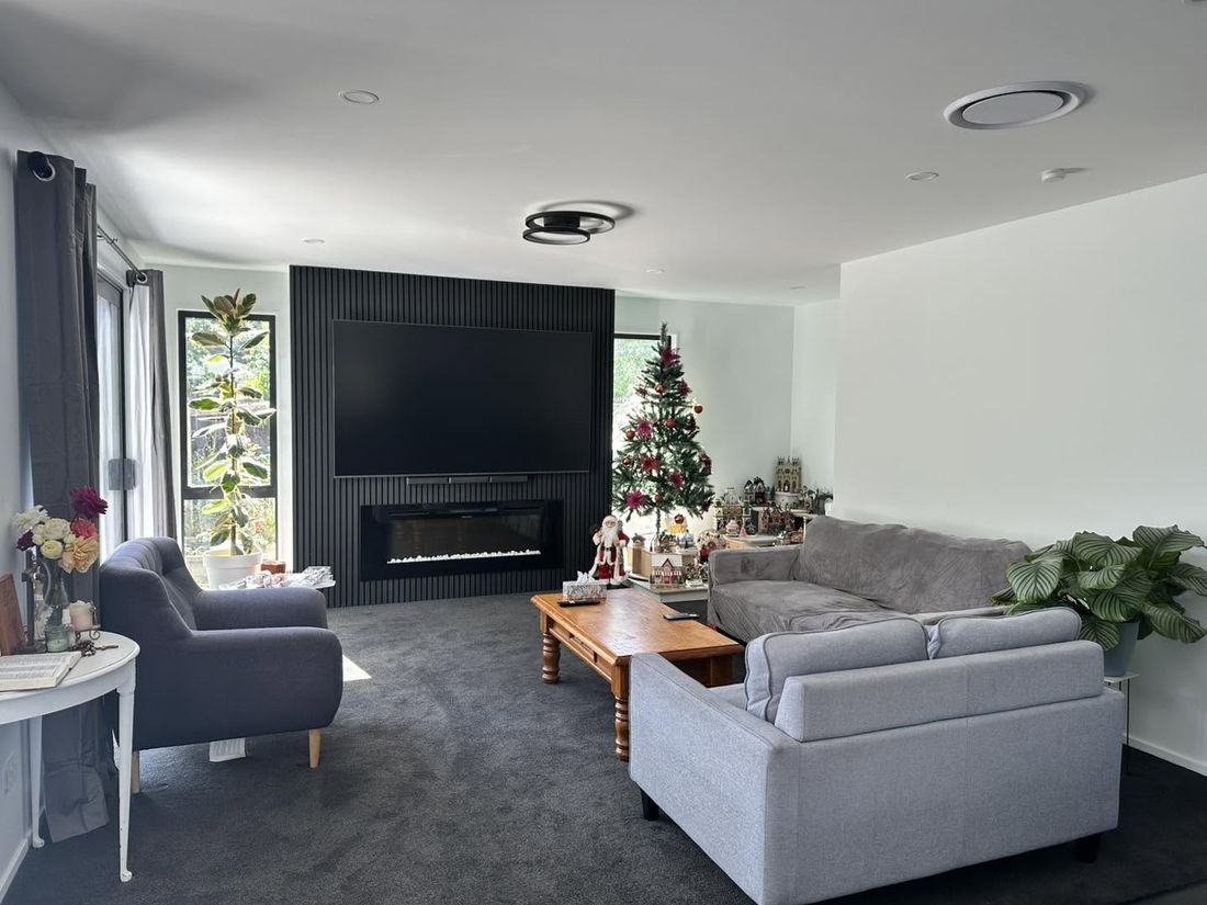 Lounge with feature slat wall, mounted TV, fireplace and feature ceiling light